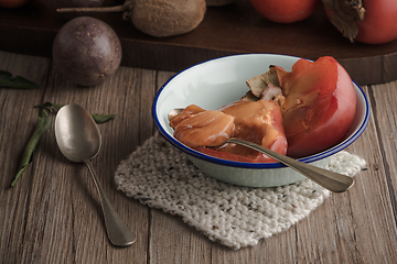 Image showing Persimmon fruit on rustic table