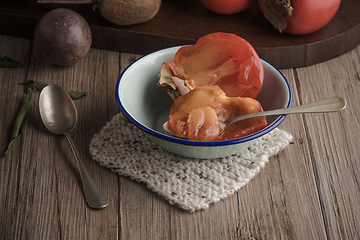 Image showing Persimmon fruit on rustic table