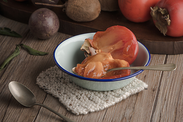 Image showing Persimmon fruit on rustic table