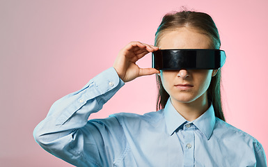 Image showing Virtual reality glasses, metaverse and futuristic tech with young woman on pink background, AI and cyberpunk. Gen z, VR goggles and video game with gamer, cyber space and scifi in the digital world