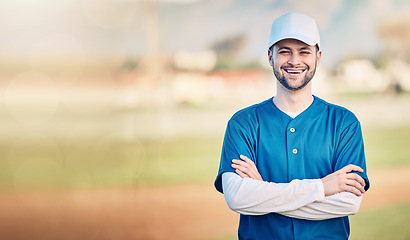 Image showing Portrait, smile and mockup with a baseball man standing arms crossed outdoor on a sports pitch. Fitness, training and happy with a young male athlete posing next to blank mock up space on a field