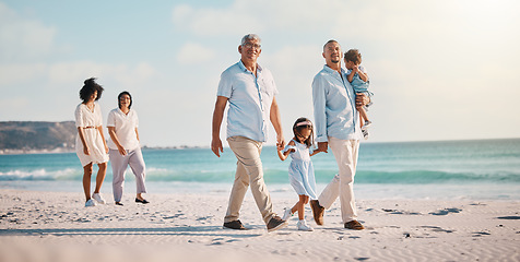 Image showing Grandparents, parents and children walking on beach for holiday, vacation and weekend trip by sea. Travel, summer and kids holding hands with big family for adventure, journey and relaxing together