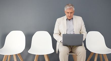 Image showing Mature business man, laptop and waiting room, queue and interview line of opportunity, recruitment process or mockup. Executive manager working on technology at studio wall, computer or hiring worker