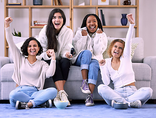 Image showing Excited, friends and women in lounge, video game and quality time with achievement, cheerful and happiness. Female gamers, group and ladies with console, celebration and joyful for victory and gaming