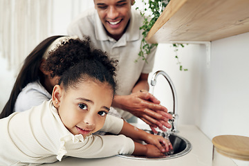 Image showing Portrait of a girl washing her hands with her family in the kitchen of their modern home. Happy, smile and child cleaning her hand with her father to get rid of bacteria, germs and dirt in a house.