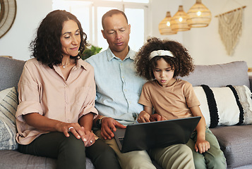 Image showing Girl watching a movie on laptop with her grandparents while relaxing on sofa in the living room. Technology, rest and child streaming video or film with grandfather and grandmother for entertainment.