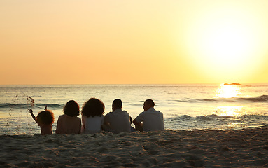 Image showing Big family, sunset view and back at beach, having fun and bonding on vacation outdoors mockup. Care, love and children, grandmother and grandfather with parents sitting and enjoying holiday time.