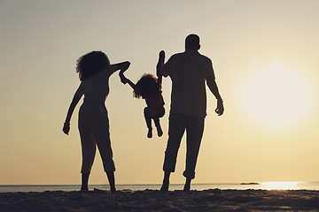 Image showing Silhouette, beach and a family with children by the ocean, playing together in nature at sunset from the back. Summer, travel or love with a mother, father and kid having fun while bonding at the sea