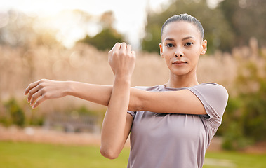Image showing Fitness, portrait and woman stretching arms in nature to get ready for workout, training or exercise. Sports, face and young female athlete stretch and warm up to start exercising, cardio or running.