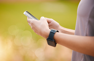 Image showing Hands, fitness and typing on phone in nature after exercise, workout or training. Sports, 5g technology and woman athlete with mobile smartphone for internet browsing, social media or web scrolling.