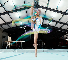 Image showing Creative, ribbon and motion blur with a woman gymnast in a studio for olympics dance training or exercise. Fitness, art and gymnastics with a female dancer in a gymnasium for rhythmic practice