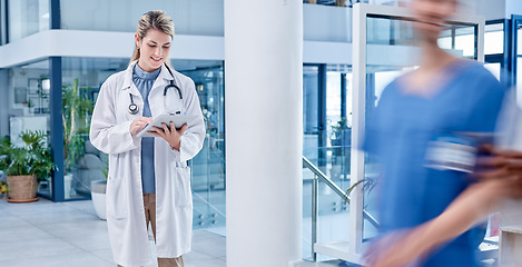 Image showing Doctor, woman and tablet in hospital with motion blur, analytics and smile for results after surgery. Medic, healthcare professional and mobile touchscreen in clinic for communication on the internet