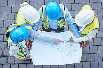 Image showing Blueprint, pointing and engineering with people on construction site from top view for planning, building and architecture. Meeting, floor plan and project with group of engineer for idea and graphic