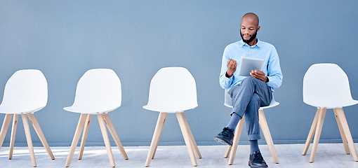 Image showing Tablet, waiting room and black man sitting for job search opportunity, career application or Human Resources. Professional person or worker alone with online technology for hr recruitment or hiring