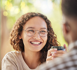 Image showing Face, smile or date and a black woman drinking coffee in the park with her boyfriend during summer. Happy, love and dating with a young female smiling at her partner for romance or affection
