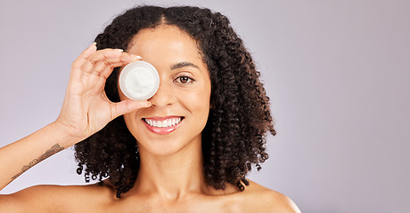 Image showing Face, skincare and black woman with cream container in studio isolated on a gray background. Dermatology portrait, cosmetics and happy female model with lotion, creme or moisturizer for skin health.