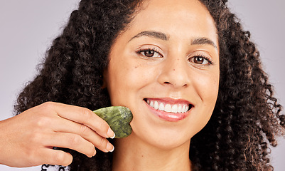 Image showing Skincare, face portrait and black woman with gua sha in studio isolated on a gray background. Dermatology, cosmetics and happy female model with tool, stone or crystal for healthy skin and wellness.