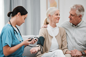 Image showing Nurse, doctor or old couple with blood pressure test consulting in hospital to monitor heart wellness. Healthcare, hypertension consultation or medical physician with a happy patient for examination