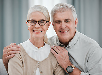Image showing Portrait, love or commitment with a senior couple hugging in the living room of their house together. Smile, space or trust with a happy mature man and woman bonding while enjoying retirement at home
