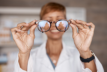 Image showing Optometry, hands and doctor with glasses in hospital or clinic for ophthalmology. Vision, healthcare and happy woman or medical optician with spectacles, frames or lenses for eye care and wellness