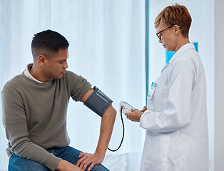 Image showing Doctor, test and man with blood pressure in hospital for heart health or wellness consultation. Hypertension, healthcare or senior medical physician with patient for examination with sphygmomanometer