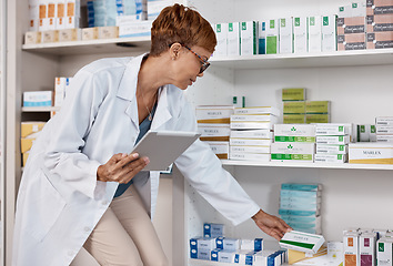Image showing Pharmacist woman, tablet and medicine shelf to check inventory and product information search. Person with pharmacy app in clinic or shop for pharmaceutical, medical and health care consultation