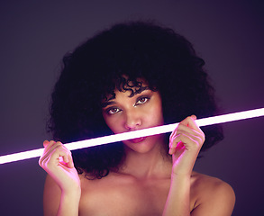 Image showing Purple light, woman and beauty portrait in studio with neon uv fashion for makeup cosmetics. Face of aesthetic gen z model black person on dark background for natural art glow on skin or afro hair