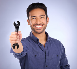 Image showing Portrait of man with wrench tool isolated on studio background for repair solution, maintenance or plumbing. Professional worker, asian person or happy plumber hand with mechanic gear for job success