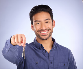 Image showing House keys, happy and portrait of a man in a studio with confidence after buying property. Happiness, proud and successful male model or new homeowner from Mexico isolated by a purple background.