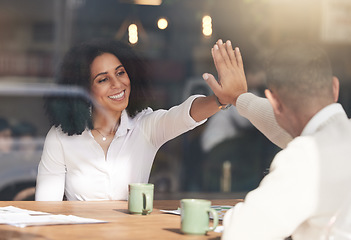 Image showing Business people, high five and celebration in meeting for planning, team collaboration or success at cafe. Black woman touching hands with colleague for teamwork, partnership or b2b at coffee shop