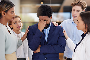 Image showing Black man, stress or headache with team for support on mental health and anxiety. Corporate leader with depression, burnout fatigue or tired and frustrated in office with empathy from men and women