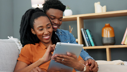 Image showing Love, sofa and black couple shopping on tablet while they relax together in the living room. African people compromise, decide and plan home apartment ecommerce order delivery logistics.