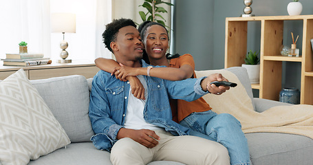 Image showing Happy, love and relax couple change channels on tv remote and watching television together on sofa at home. woman hug on man while enjoying streaming entertainment show, series and movies in house