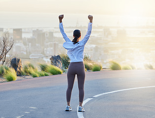 Image showing Run celebration, woman workout and fitness goal of a excited and happy runner on a road. Cityscape sunset, freedom and motivation of a female athlete back feeling exercise success from running