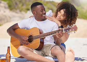 Image showing Romance, music and interracial couple with a guitar at the beach, bonding and entertainment. Love, happiness and black man playing a song on an instrument with a woman listening at the ocean