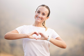 Image showing Portrait, runner and hand sign by woman with heart, symbol or gesture for wellness against blurred background. Face, happy and girl with emoji hands, shape and message for self love, peace and care