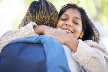 Image showing Happy students, backpack and hug in park, garden or school campus bonding, friends acceptance or community support. Smile, Indian and women in embrace on university college for good luck or thank you