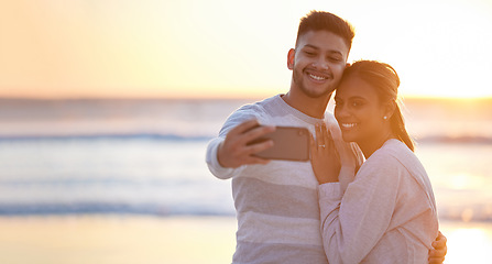 Image showing Couple, beach selfie and sunset love for happiness, save the date engagement announcement or mockup. Man, woman and take photograph at sea of happy holiday, peace or relax at ocean, travel or freedom