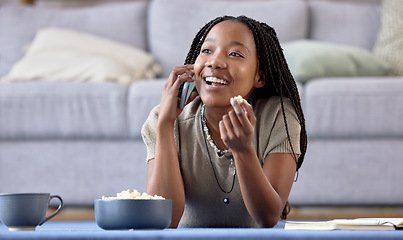 Image showing Lounge phone call or black woman with smile, connection or study break with popcorn. African American female student, girl or smartphone for conversation, living room or happiness with laugh or snack