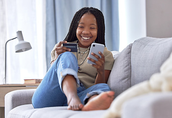 Image showing Online shopping, credit card and black woman with phone on sofa for financial banking, ecommerce and fintech. Happy customer in house for mobile finance, digital money and fast food delivery payment