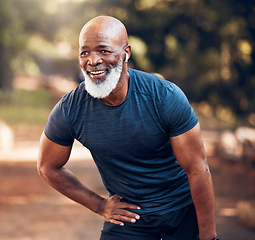 Image showing Running, break and black man breathing for fitness, exercise and workout in nature, park or garden. Senior male, sports and rest with smile, motivation and healthy cardio wellness outdoors with music