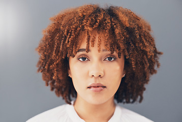 Image showing Beauty, afro and black woman face or activist for empowerment and looking serious, confident and proud. Portrait, head and African American female with curly hair isolated in gray background