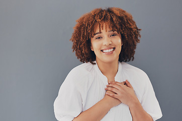 Image showing Black woman, portrait and face with hands on chest or heart for love, care and support for charity. Face of African person with hand for gratitude, kindness and trust or thank you on gray background