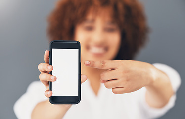 Image showing Mockup, blank phone screen and hand pointing to digital marketing, advertisement and web message. Discount, sale and promotion deal mock up of a black woman in a studio with blurred background