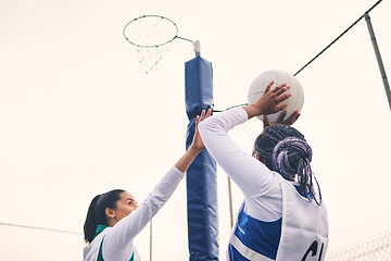 Image showing Sports, netball and black woman shooting ball in match for competition, exercise or practice. Training, wellness or players playing game for workout, exercising or competitive performance outdoors.