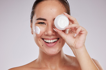 Image showing Skincare, product and face cream with portrait of woman in studio for grooming and cosmetics on grey background. Facial, model and asian girl relax with luxury beauty, skin and sunscreen lotion