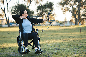 Image showing Outdoor archery, disabled woman in wheelchair and challenge for active sports lifestyle in Canada. Person with disability in a park, fitness activity to exercise arms with bow and arrow for hobby