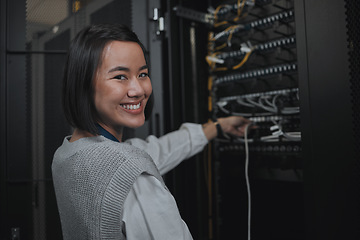 Image showing Asian woman, portrait smile and technician by server for cabling, networking or system maintenance at office. Happy female engineer smiling in cable service, power or data management or admin control