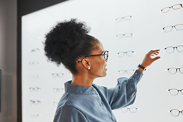 Image showing Vision, optometry and black woman shopping for glasses, spectacles or frames at optical store. Eye care, ophthalmology and happy female customer with choice or decision for retail lenses or eyewear.