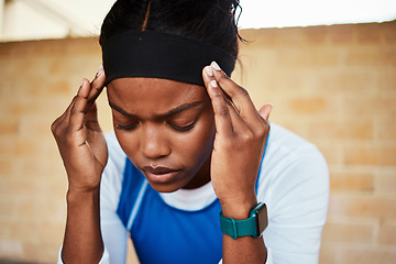 Image showing Fitness, headache and black woman in pain during run, exercise or workout against brick wall background. Sports, migraine and girl suffering with ache, discomfort and fatigue during cardio routine